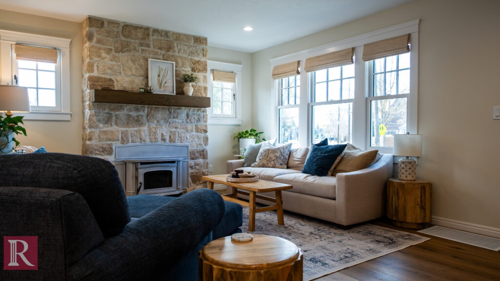 Bright Boise living room remodel with stone fireplace, neutral furniture, and large windows for natural light.