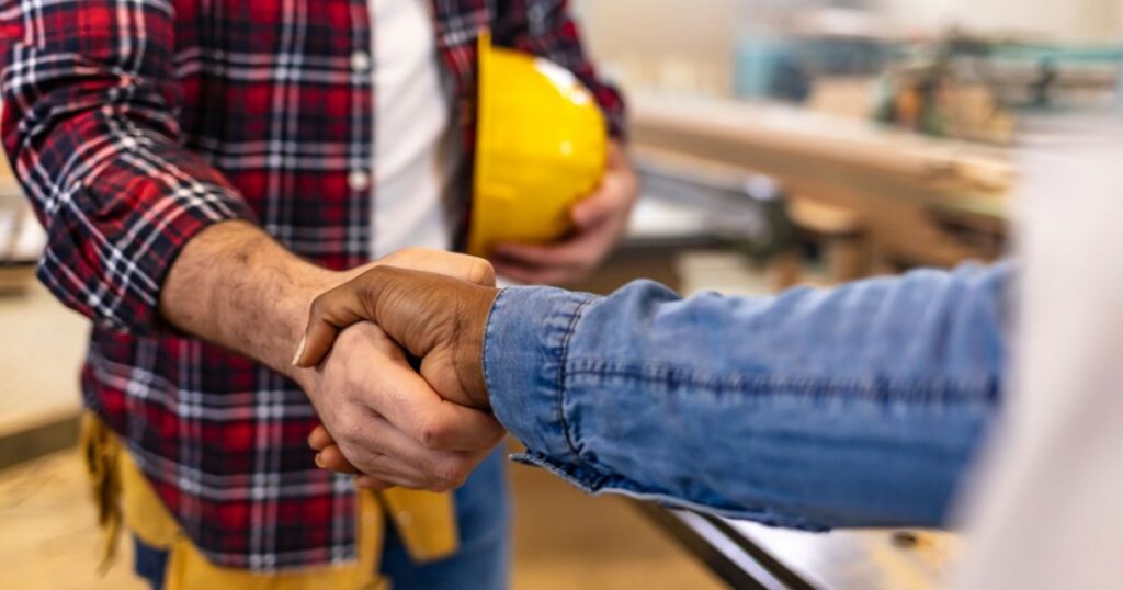 Homeowner shaking hands with a remodeling contractor during a Boise home renovation consultation